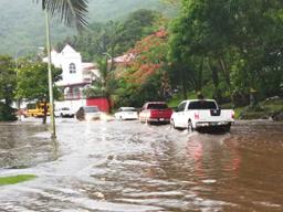 Vehicles trying to pass over a pool of water near Fatuoaiga