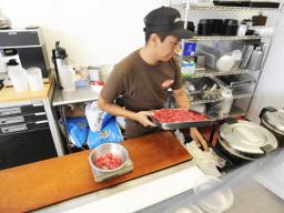 Saul De La Rosa prepares a tray of poke at Aloha Poke Shop in downtown Honolulu