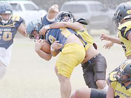 Wildcats defender bringing down the Crusaders ball carrier 