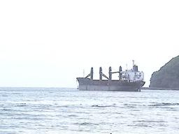 Wise Honest being towed by an off-island tugboat out of the harbor