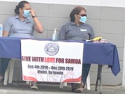 Two ASG workers wearing protective nose/ mouth masks,