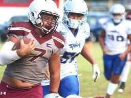 Tafuna Warriors ball carrier at the sidelines and