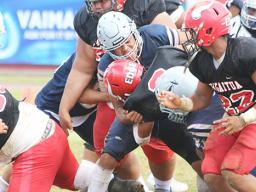 Samoana Sharks defensive captain, Masaichi Aviu breaks to the backfield and sacks Fitu Amata