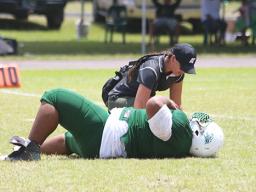 Florence Wasko tending to one of the many injured in Saturday's games, this time it is Cyan Fiatoa