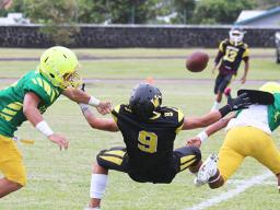 A pass from Jerry Isaako of the Wildcats intended for his wide receiver is broken up by Ben Tikeri