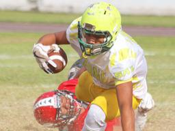 A Leone Lions running back is dragged down in the backfield by a Viking defender