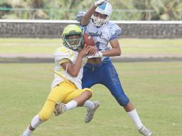 A Leone Lions receiver tries to gain control of the ball while defending was Prodieus Lutu-Fuga of the Sharks