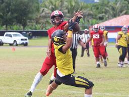 PJ Tufugafale securing a catch against Faga’itua’s Tevita Tevita 