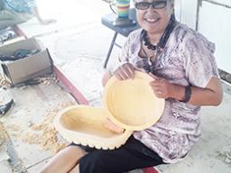 Andre Samoa with her kava bowls she carved