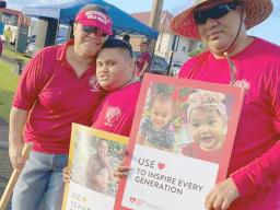 Famlies with signs at World Hearts Day wave