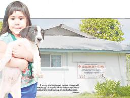 Young girl with her puppy in front of Vet clinic.