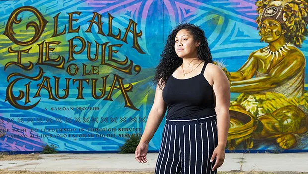 Leah McKenzie, of Long Beach standing before the mural.