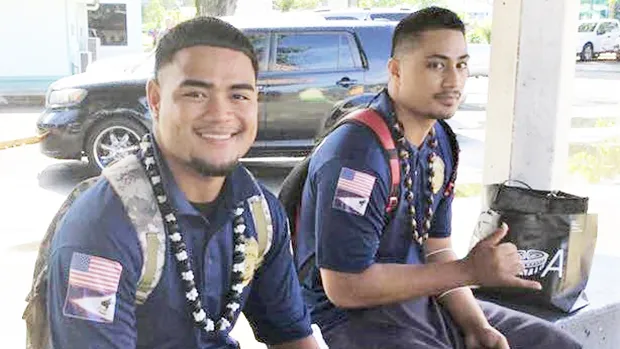 Two young men at bus stop