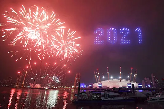 Fireworks and drones illuminate the night sky over London