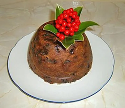 Christmas steamed pudding on a white plate