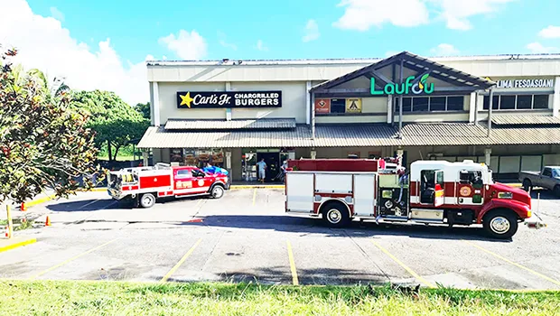 Fire trucks and EMS personnel in front of Carl's Jr