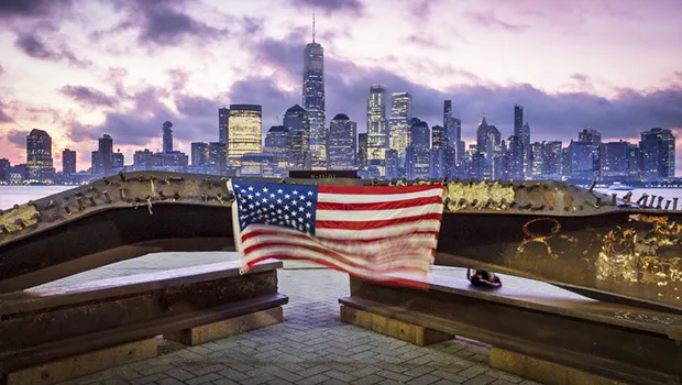 A U.S. flag hanging from a steel girder, damaged in the Sept. 11, 2001