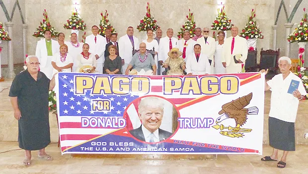 Sen. Tuaolo Manaia Fruean (left) holding the “Pago Pago for Trump” banner with Pulu Ae Ae Jr, while Paramount Chief Mauga T. Asuega, his wife and village traditional and church leaders (on stage)