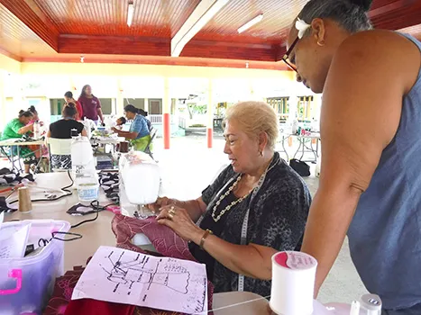sewing instructor, Diana Tarrant teaching certain methods of sewing to a participant