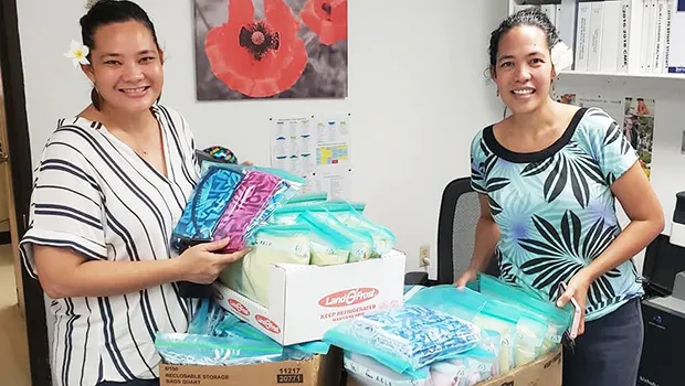 Elenor Lutu-McMoore (left) and Christinna Lutu-Sanchez with gowns and masks