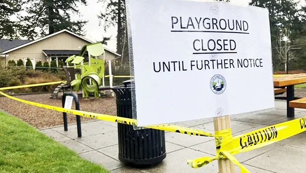 Police caution tape surrounds a playground in Lake Oswego, Ore.
