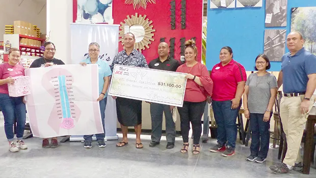 American Samoa Community Cancer Coalition board chairman, Taotasi Archie Soliai  accepts donation from Neil's Ace Home Center