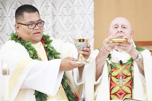 Deacon Ese’ese Tui assists Bishop Larry Silva