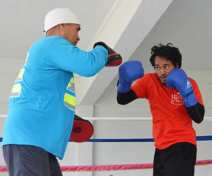 Trainer, Sala Senele Etuale hitting the pad with one of the local boxers 