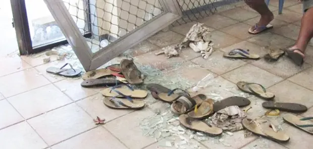 Broken glass and scattered slippers