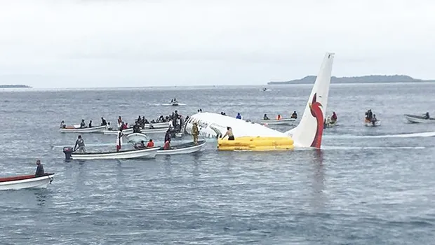local fishing boats move in to recover the passengers and crew of Air Niugini flight