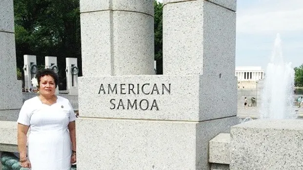 Congresswoman Uifa’atali Amata next to American Samoa pillar