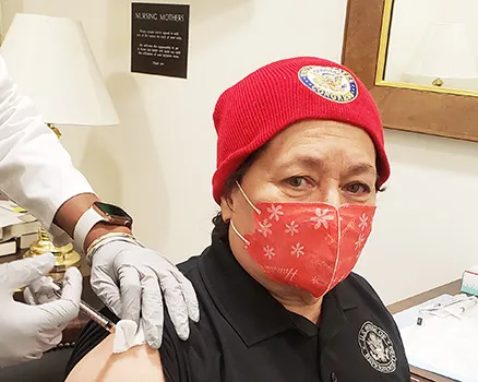 Amata getting vaccinated while wearing a mask