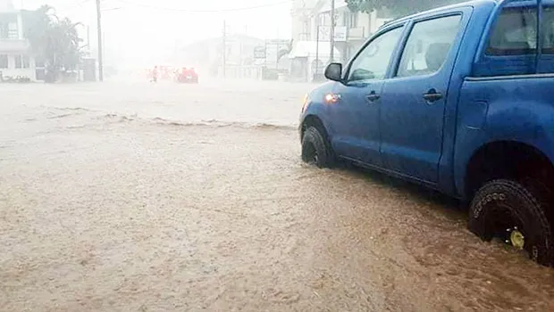 Car stalled on flooded road in Apia
