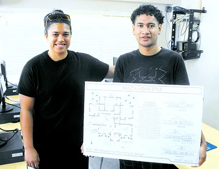 ASCC instructor Valentine Talamoni (left) advises student Henry Aiava on his work 