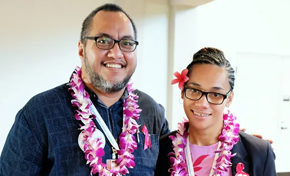 Derek Helsham (left) congratulates ASCC alumnus Alice Tausaga