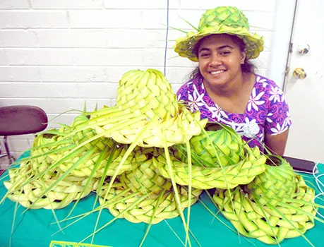 Rejoyce Saega displays her coconut leaf hats