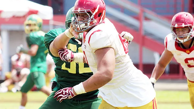 Tafuna Warriors Sophomore Francis Mauigoa breaking through Leone Lions wall