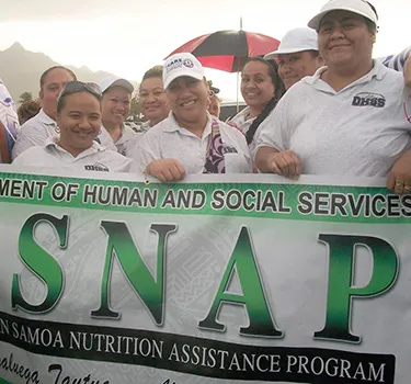 SNAP staff with sign
