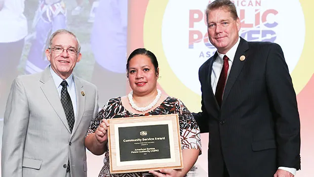 Edna Noga (middle) accepting for ASPA, the American Public Power Association Community Service Award