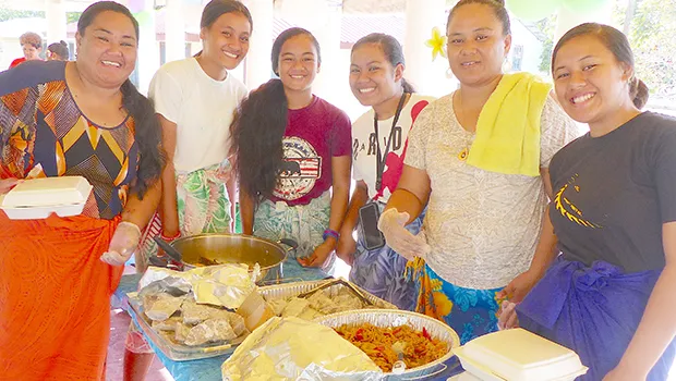 Array of yummy food with young ladies serving
