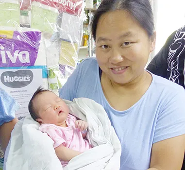 Mrs. Mrs Zhang Chao Jun and her New Year baby