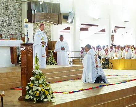 Bishop-elect Reverend Father Etuale kneels