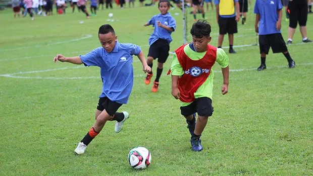 A Black Roses player (left) and Lion Heart opponent battle for possession 