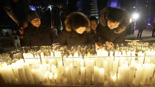 Buddhist light candles for New Year 2019
