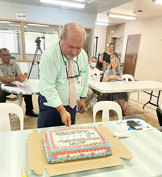 CEO Moefa'auo William Emmsley cuts cake