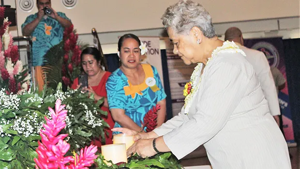 First Lady Cynthia Malala Moliga lights a candle during last Thursday’s Candlelight Memorial for World Suicide Prevention Day
