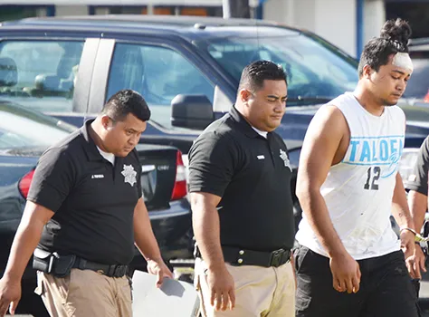 Chanel Lafua handcuffed with police guards