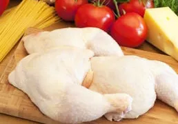 Pieces of chicken on a cutting board.