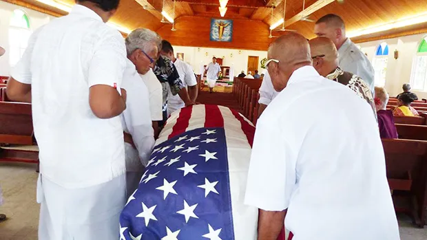 Pallbearers escorted into the Futiga Catholic Church last Thursday during the family service, the U.S. flag-draped coffin of  Ulufaleilupe Fuimaono Ta’aala Leulua'ialii Filifaiesea Fa'asuamalie