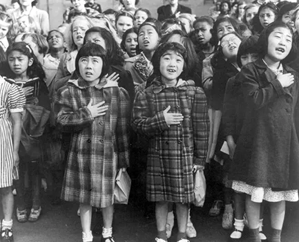 children at the Weill public school in San Francisco recite the Pledge of Allegiance. Some of them are evacuees of Japanese ancestry who will be housed in War Relocation Authority centers for the duration of World War II.
